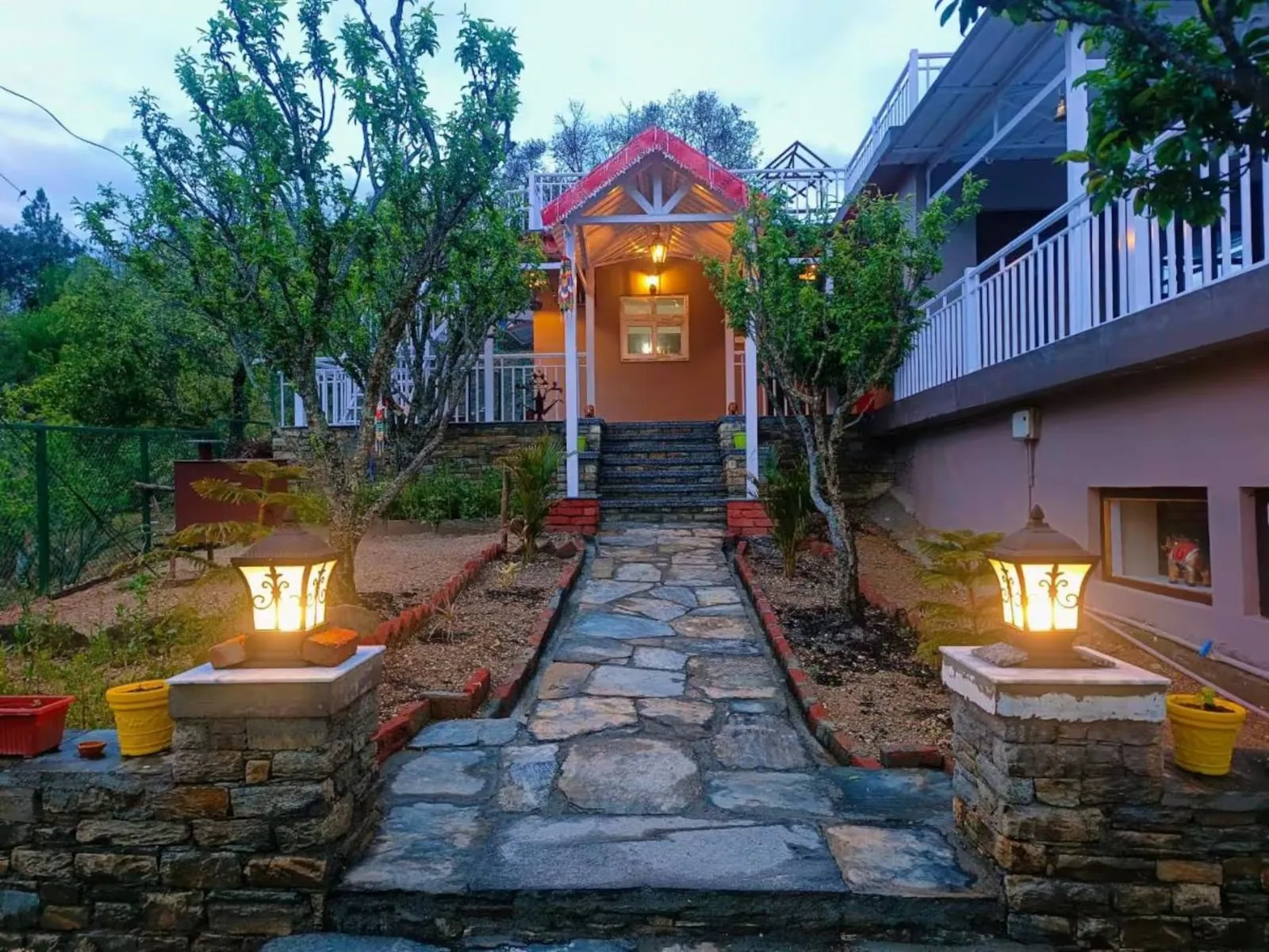 Stone path and lantern lit entrance to WindyRidge Plum Orchard Villa at Darima, Mukteshwar