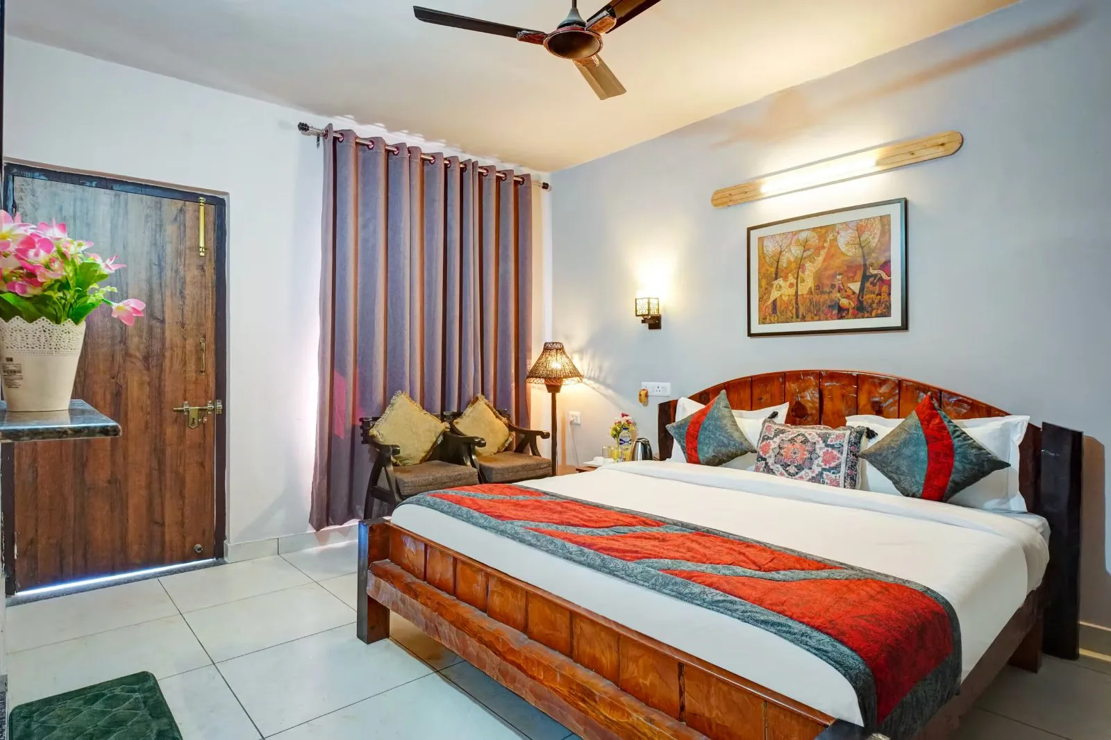 Bedroom with a carved wooden bed at WindyRidge Plum Orchard Villa, Mukteshwar