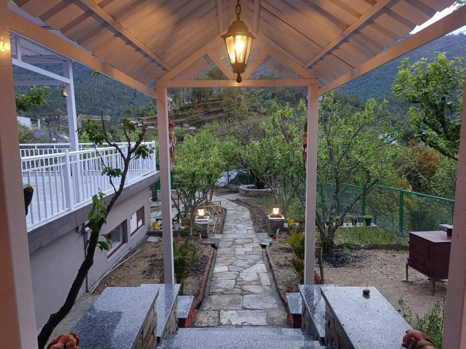 Covered sit out and the path through the orchard at WindyRidge, Mukteshwar
