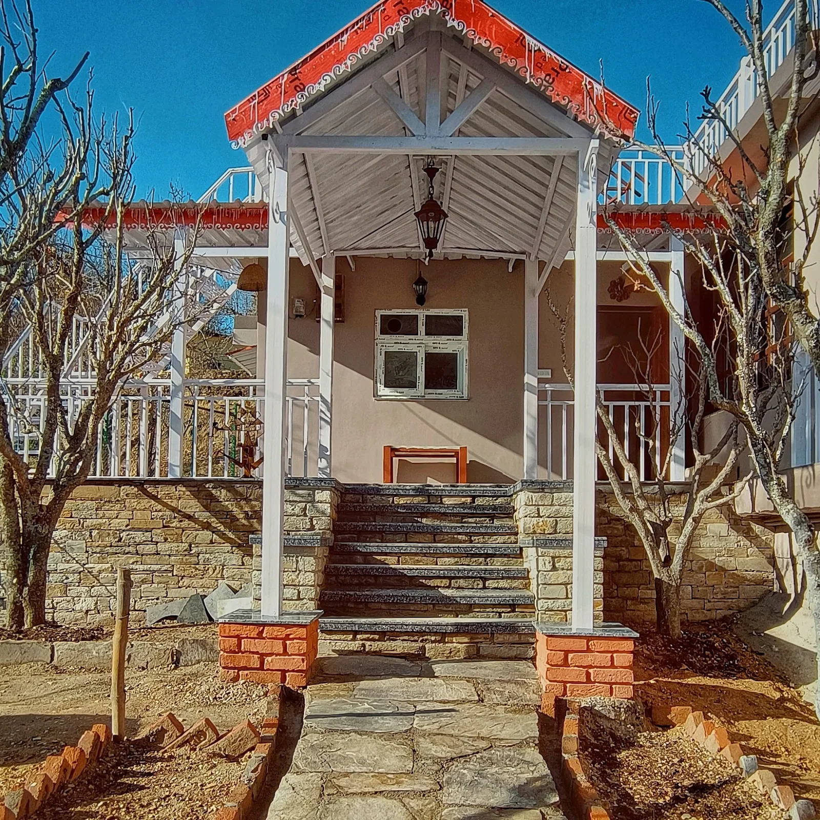 The porch and red roof of WindyRidge villa at Darima near Mukteshwar
